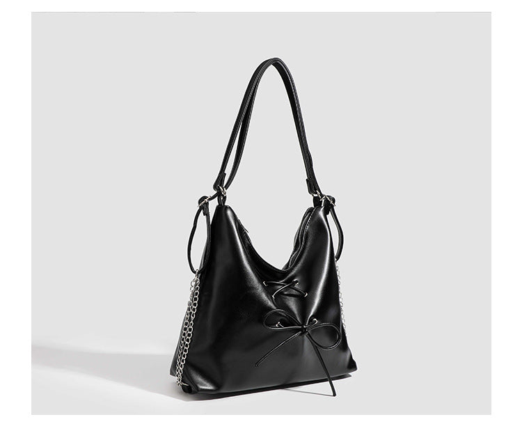 Glossy leather-look hobo shoulder bag with front bow lacing detail and silver-tone chain strap, detail view 22
