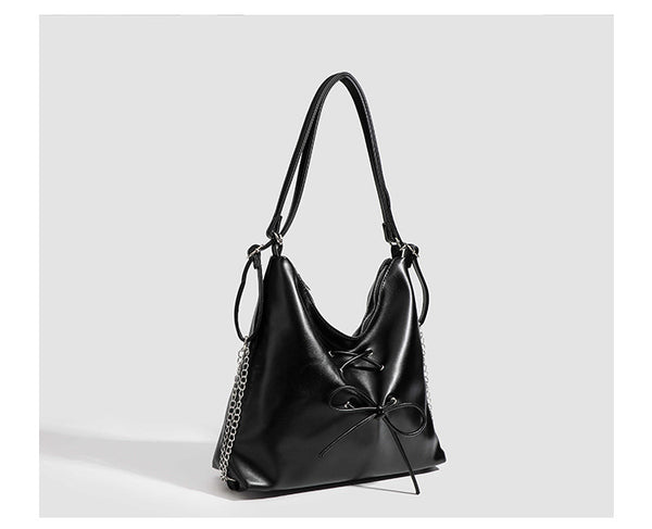 Glossy leather-look hobo shoulder bag with front bow lacing detail and silver-tone chain strap, detail view 22