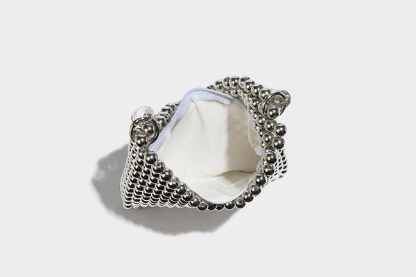 Small silver metallic beaded mini bag with braided rhinestone top handle and detachable chain crossbody strap, detail view 13