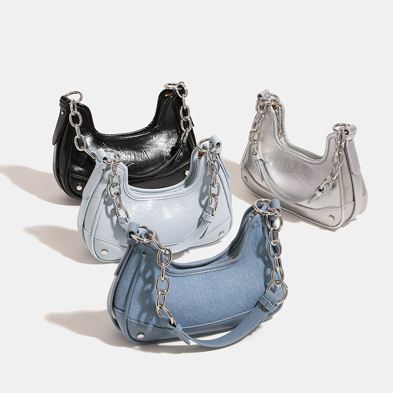 Small crescent hobo crossbody bag with denim-look fabric panel, smooth leather-look trim, chunky silver-tone chain strap