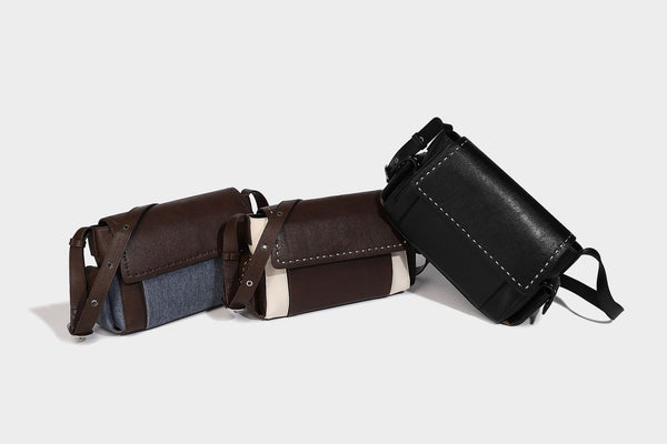 Structured flap crossbody bag in dark brown and cream color-block with white contrast stitching, adjustable shoulder strap