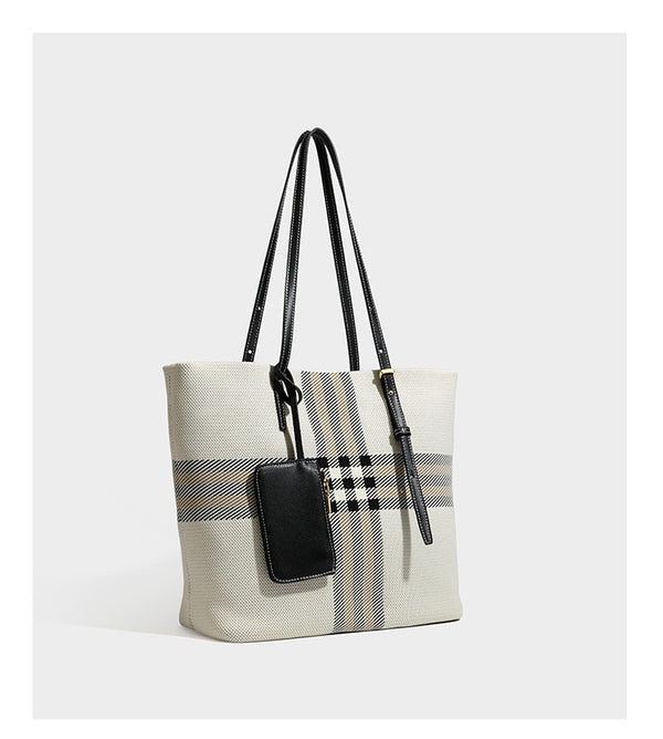 Large structured plaid check tote bag with smooth tan leather-look shoulder straps, attached front zip pouch, and gold-tone