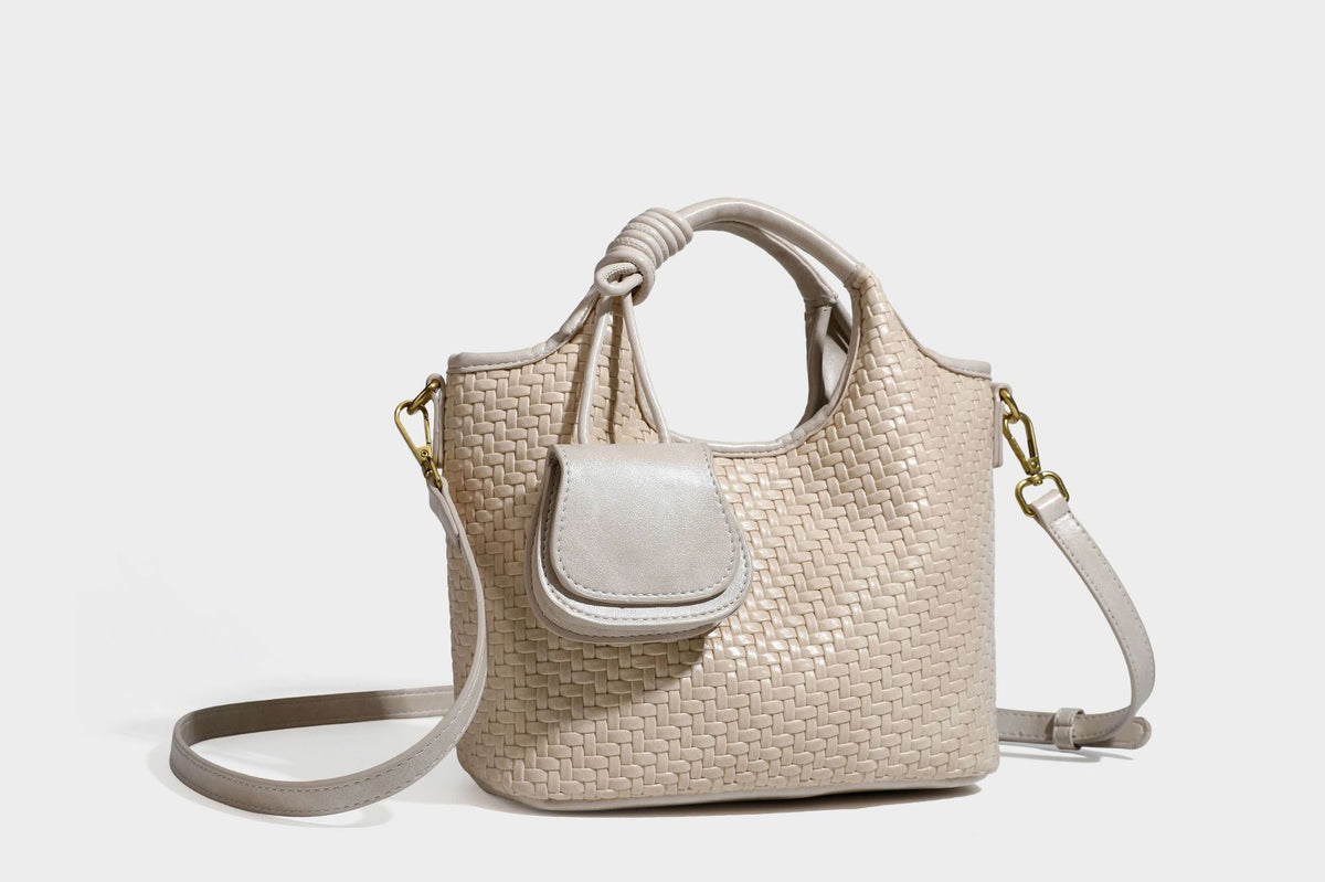Woven leather-look tote bag in mocha brown with knotted top handle, front flap pocket, and detachable crossbody strap with