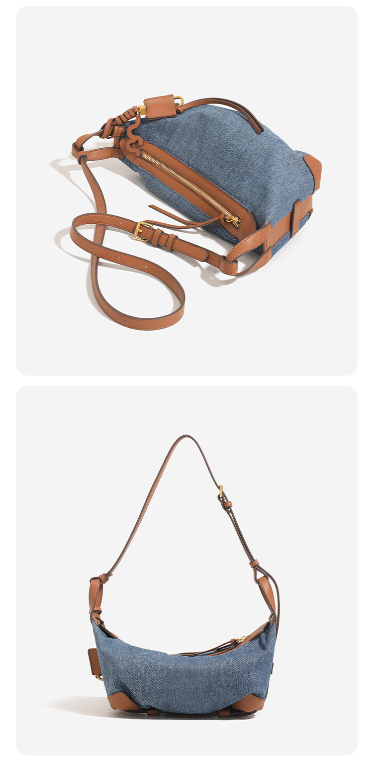 Washed denim canvas crescent hobo bag with tan leather-look trim, knotted strap detail, and gold-tone zipper hardware, detail