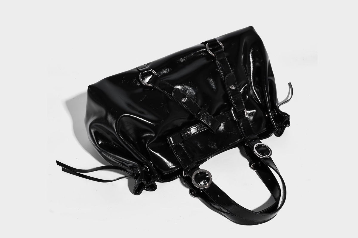 Glossy patent-look slouchy tote bag with ruched drawstring sides, dual top handles, silver ring hardware, and detachable