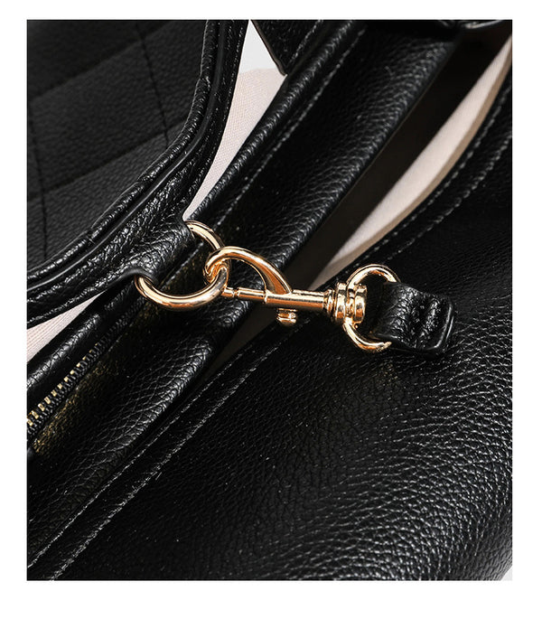 Structured black diamond-quilted shoulder bag with gold-tone turn-lock flap closure and dual round shoulder straps, detail