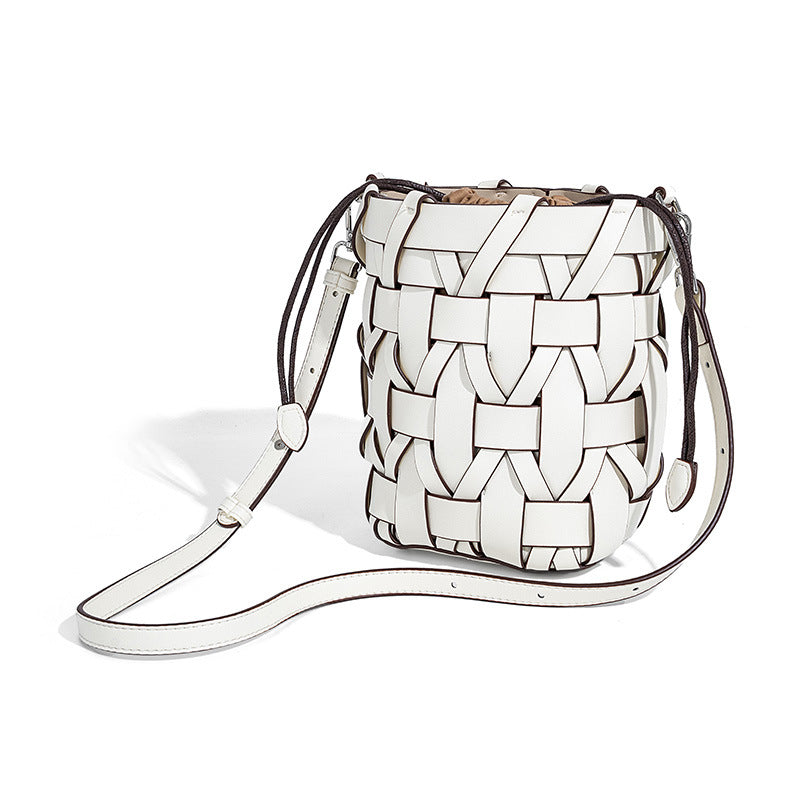 Small woven leather-look bucket bag with interlaced strip exterior, drawstring closure, and adjustable crossbody strap