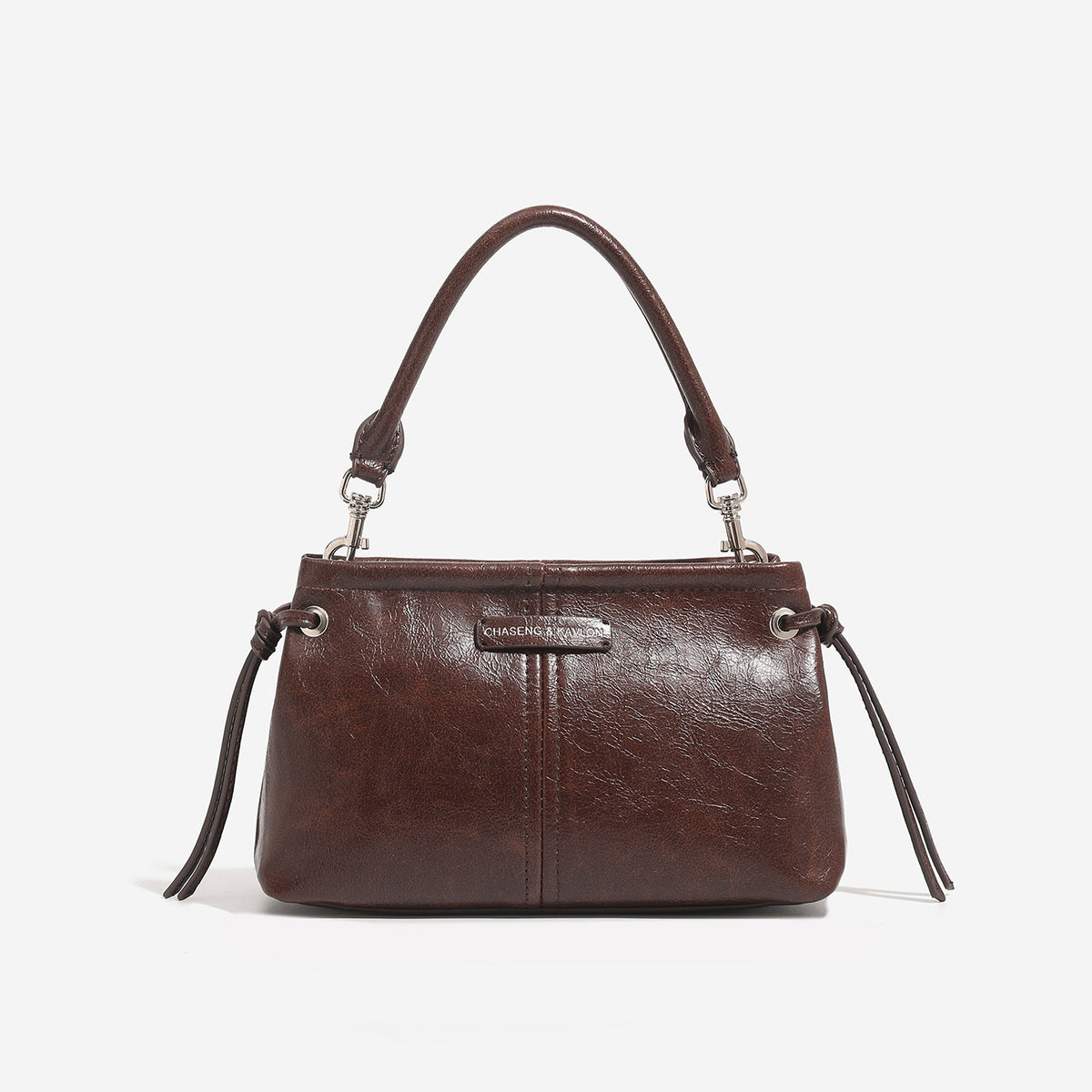 Small retro convertible shoulder bag with glossy leather-look finish, side drawstring ties, top zip closure, and silver-tone