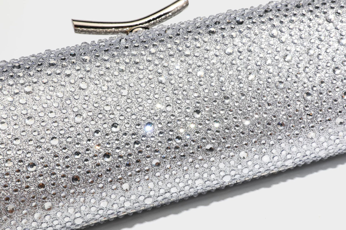 Structured rectangular hard-case clutch bag covered in all-over rhinestone crystal embellishment with curved kiss-lock top