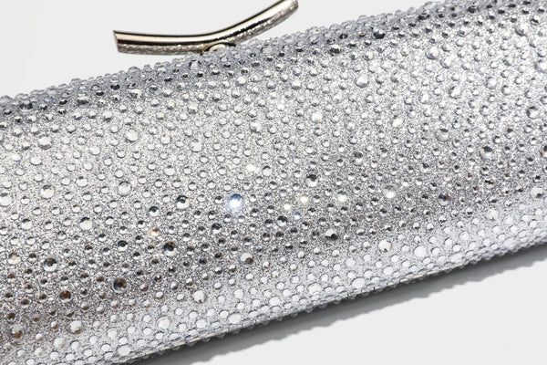 Structured rectangular hard-case clutch bag covered in all-over rhinestone crystal embellishment with curved kiss-lock top