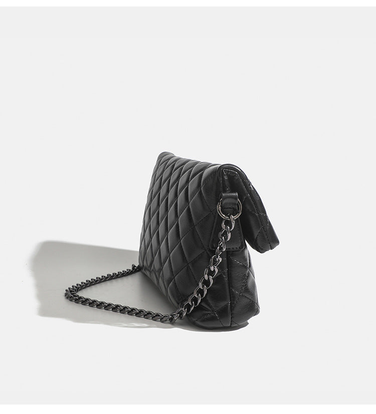 Quilted diamond-stitch flap crossbody bag with gunmetal chain strap and cut-out bar handle, detail view 10