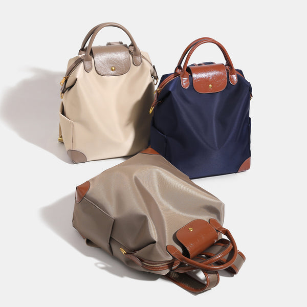 Soft rectangular nylon convertible backpack handbag with leather-look trim, snap-flap closure, top carry handles, padded