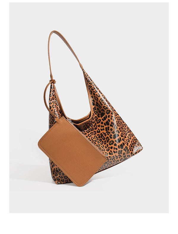 Glossy leopard-print slouchy shoulder bag with long strap and detachable tan zip pouch, detail view 8
