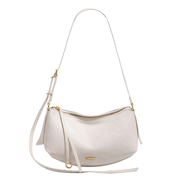 Compact soft rounded zip-top shoulder bag with gold-tone hardware and adjustable crossbody strap, detail view 5