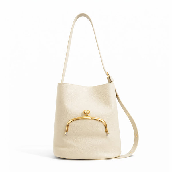 Pebbled textured bucket bag with gold-tone kiss-lock front pocket and adjustable single shoulder strap, detail view 2