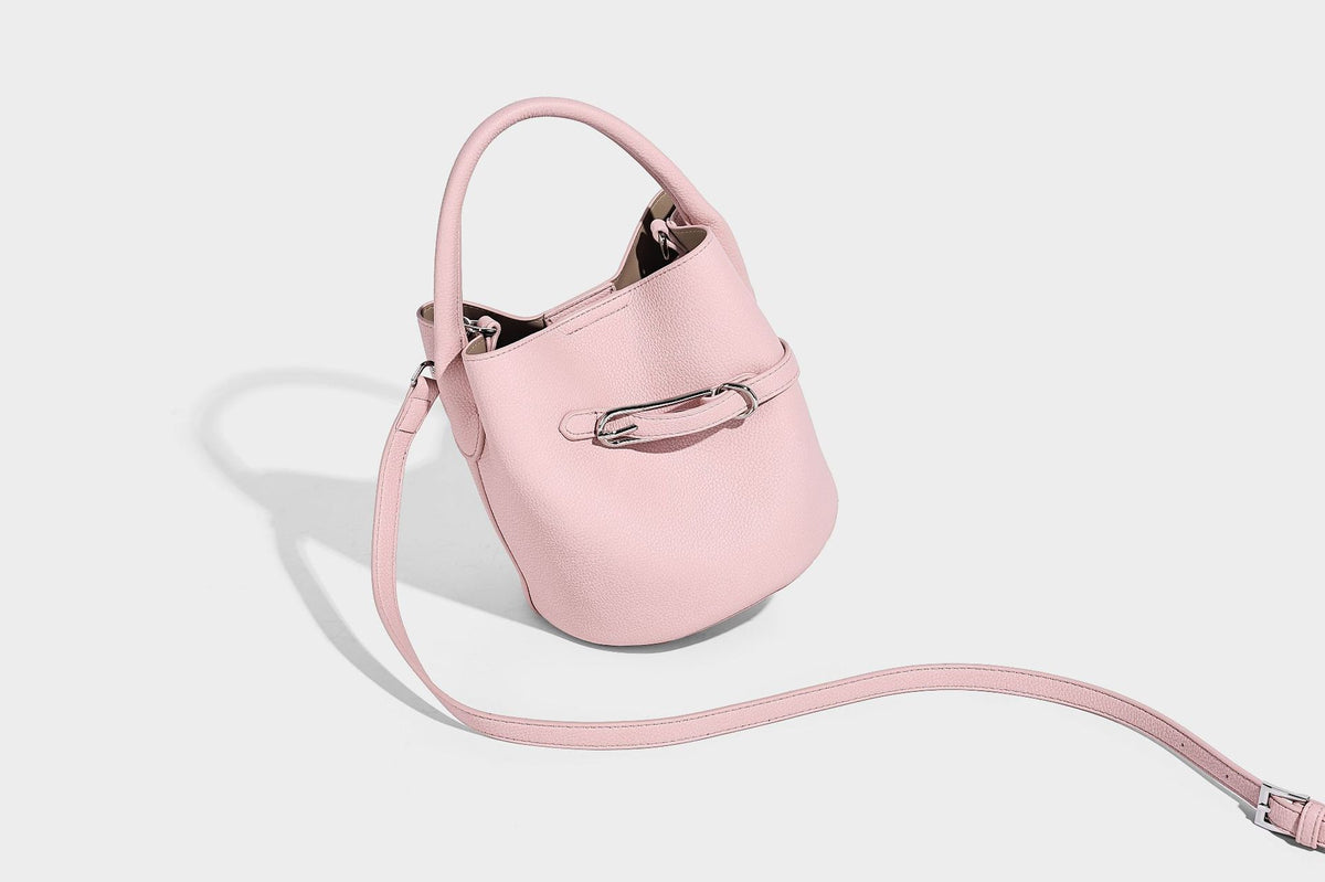 Mini pebbled leather-look bucket bag with front buckle strap, silver-tone hardware, top handle, and detachable shoulder