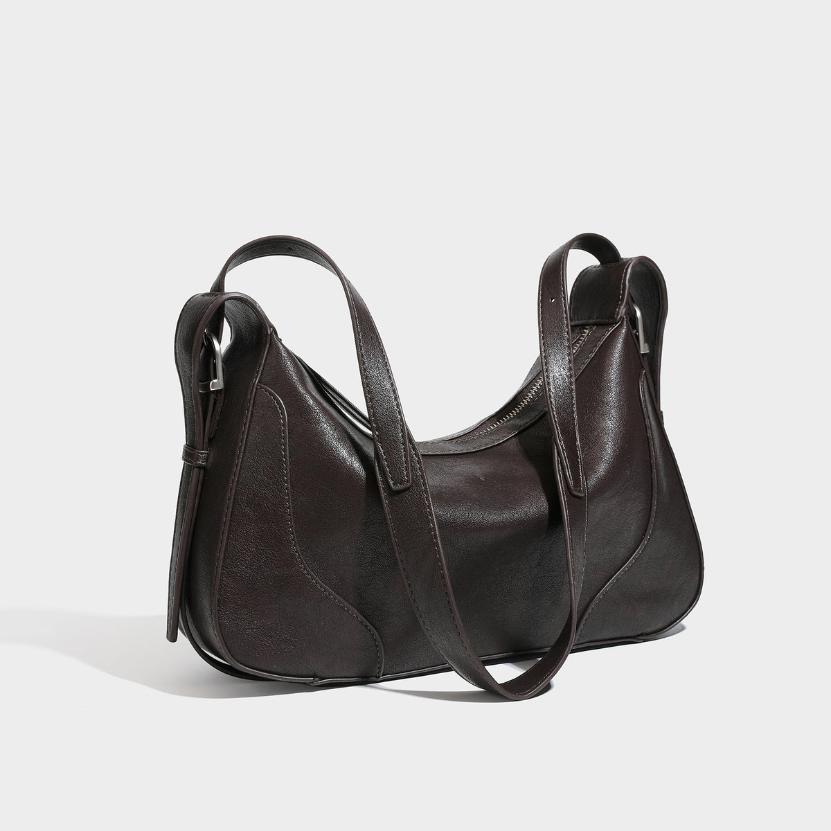 Slouchy crescent hobo shoulder bag in dark brown pebbled leather-look finish with zip top and long shoulder strap, detail
