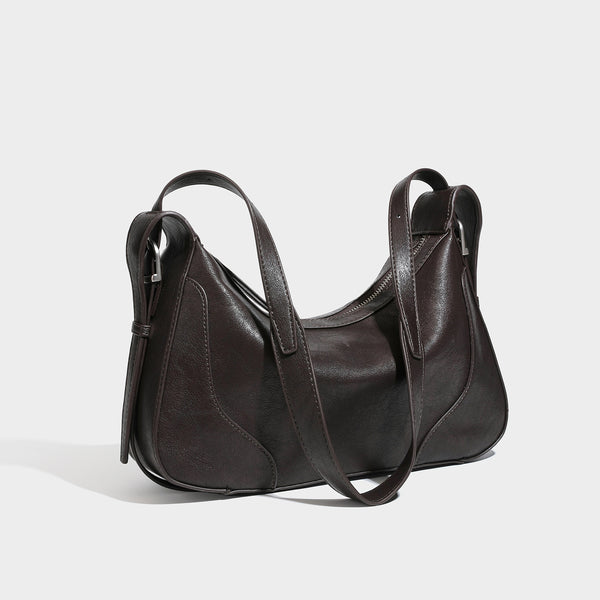 Slouchy crescent hobo shoulder bag in dark brown pebbled leather-look finish with zip top and long shoulder strap, detail