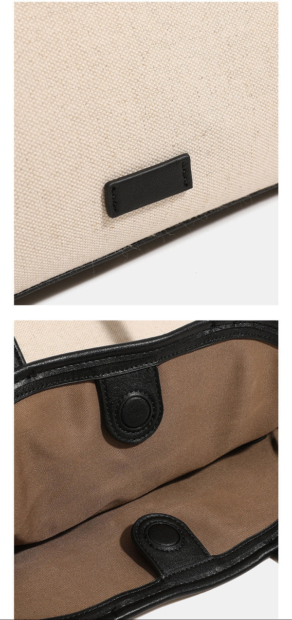 Cremefarbener Trapez-Shopper aus Canvas mit Besätzen in schwarzer Lederoptik, zwei Schulterriemen und goldfarbenen Ringbeschlägen, Detailansicht