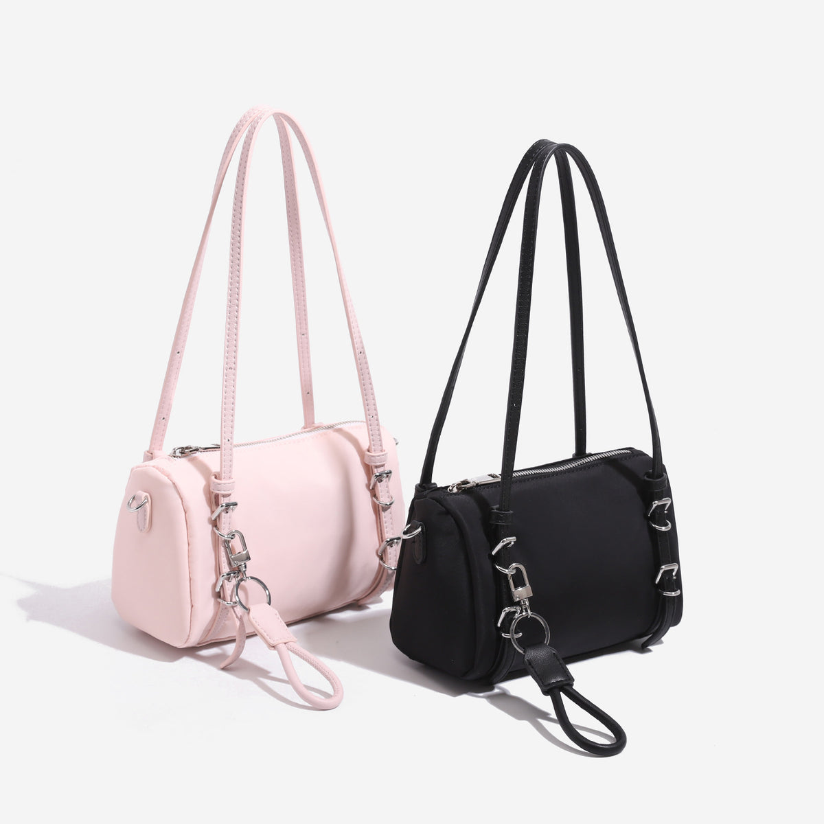 Compact nylon Boston barrel bag with zip-top closure, silver-tone hardware, dual slim handles, and detachable crossbody