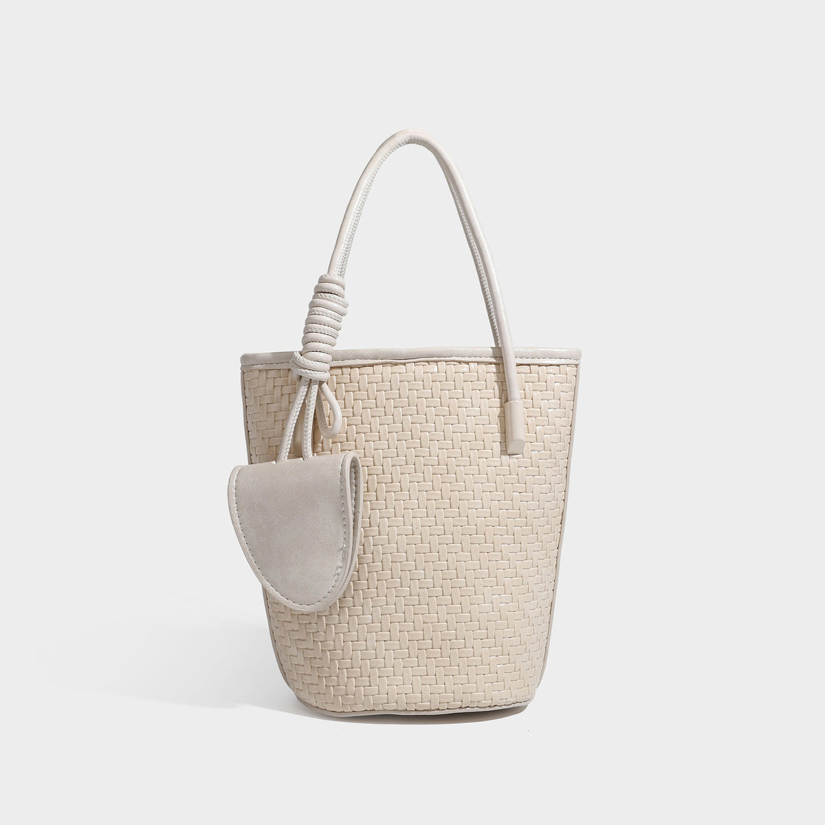Structured woven-texture leather-look bucket bag in brown with knotted top handles, small front flap pouch, and adjustable