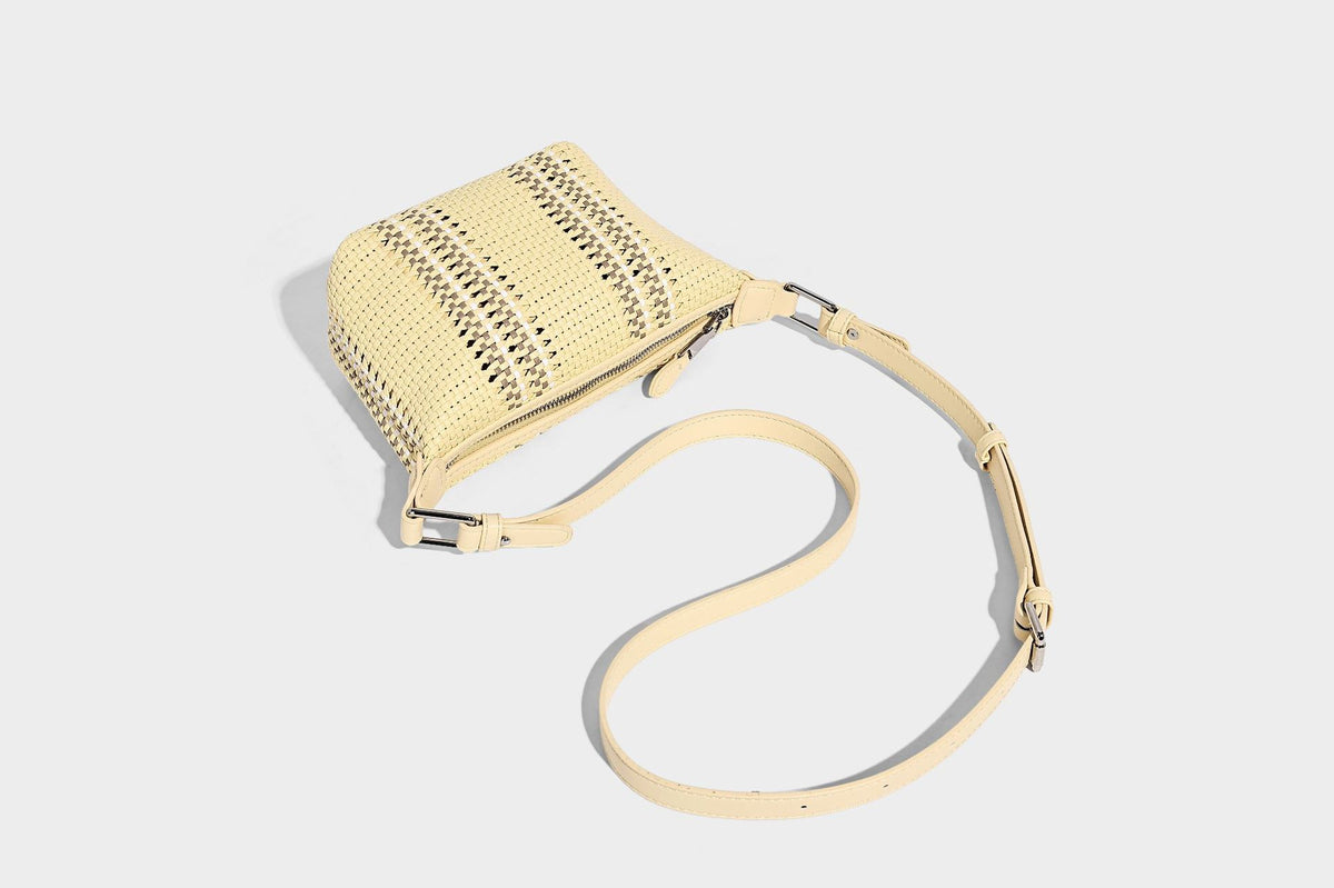 Small woven crescent shoulder bag with leather-look trim, zip closure, silver-tone ring hardware, and beaded tassel charm