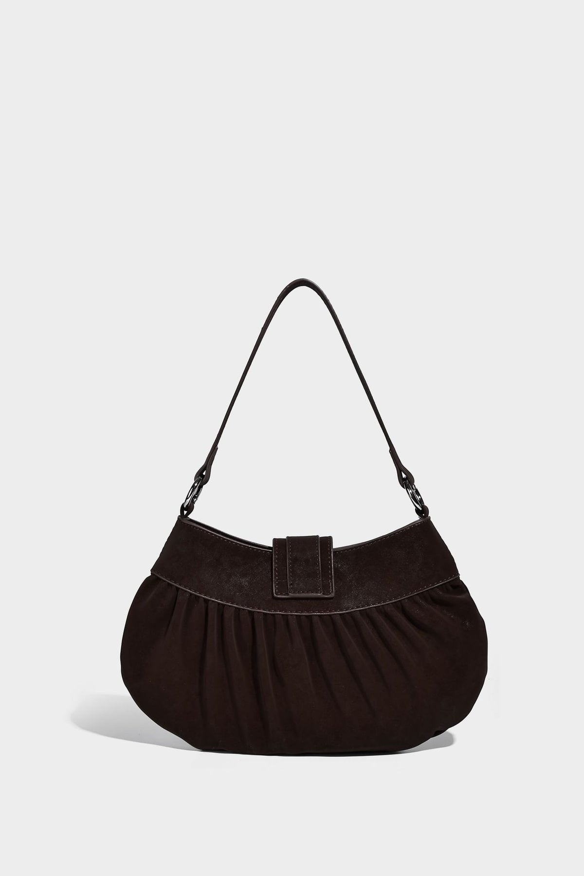 Ruched shoulder bag with curved flap, silver star studs, dangling starfish charm, and adjustable crossbody strap, detail view