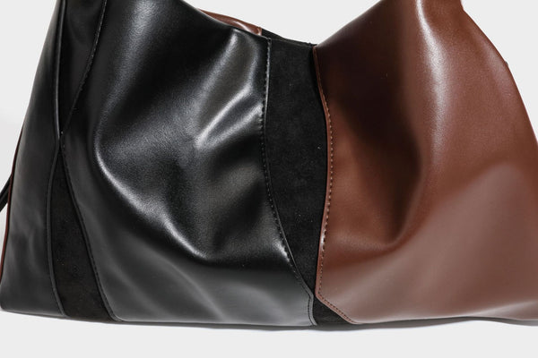 Two-tone black and brown leather-look slouchy shoulder bag with beaded tassel charm and silver-tone hardware, detail view 27