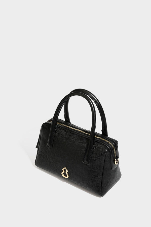 Small structured pillow satchel bag with pebbled leather-look finish, dual rolled top handles, gold-tone gourd emblem, and