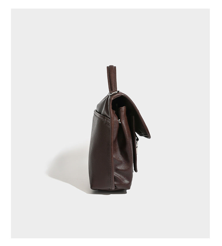 Structured rectangular flap satchel in espresso brown leather-look finish with silver-tone turn-lock buckle, top handle, and