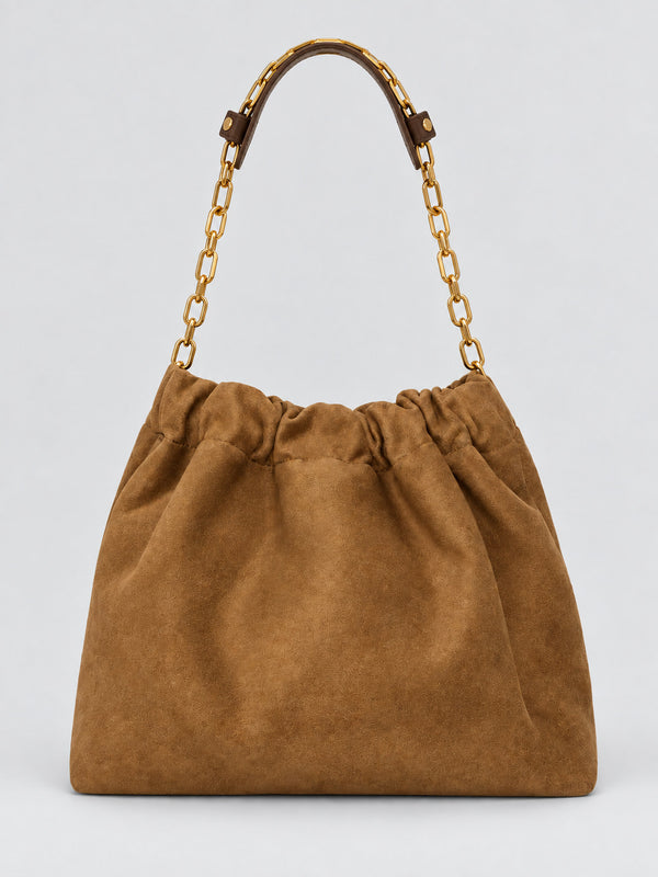 Slouchy suede-look shoulder bag with gathered top, angular stitched paneling, and chunky gold-tone chain strap, detail view