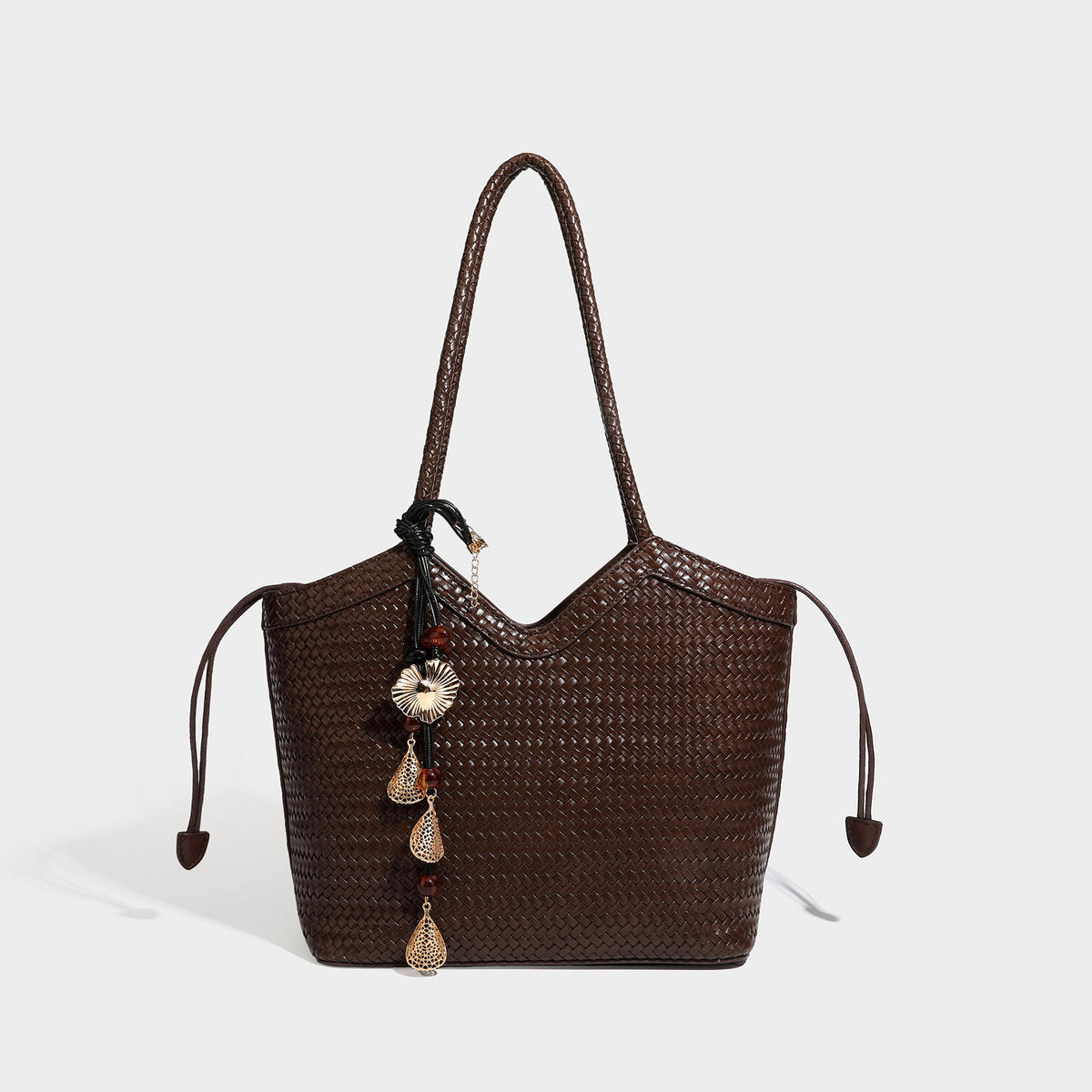 Woven tote bag with braided shoulder straps, drawstring closure, and dangling metal-and-bead charm, detail view 6