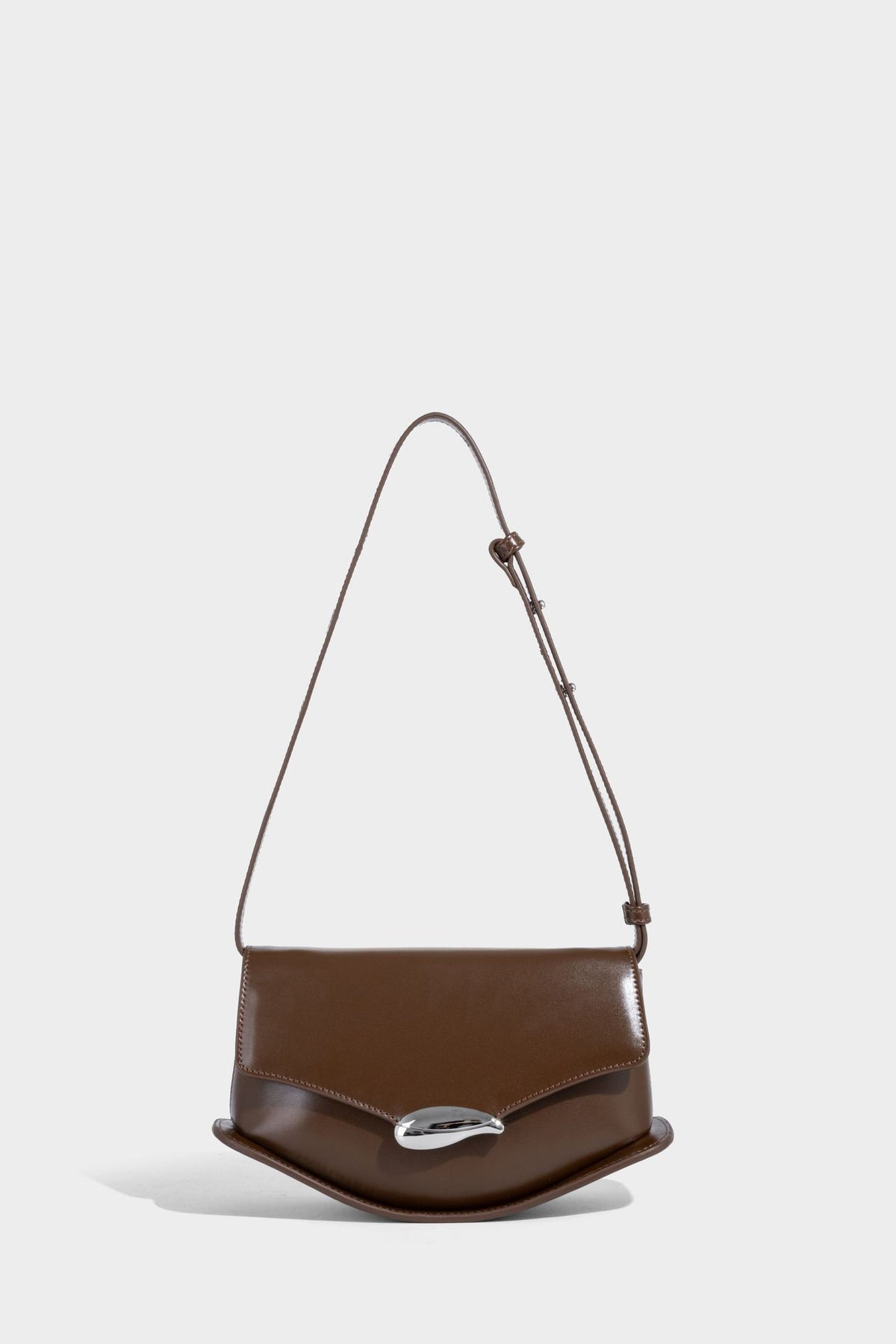 Small structured saddle bag with glossy leather-look finish, angular flap front, silver-tone metal clasp, and slim