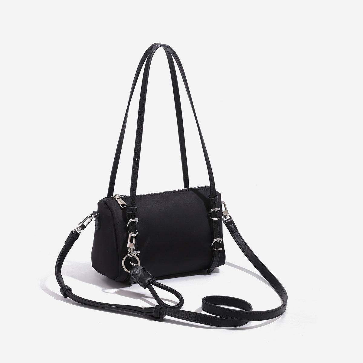 Compact nylon Boston barrel bag with zip-top closure, silver-tone hardware, dual slim handles, and detachable crossbody