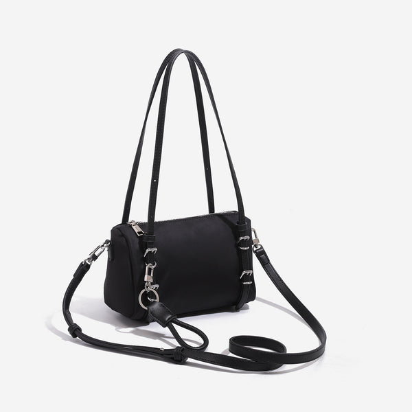 Compact nylon Boston barrel bag with zip-top closure, silver-tone hardware, dual slim handles, and detachable crossbody
