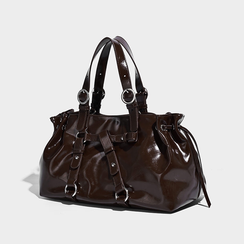 Glossy patent-look slouchy tote bag with ruched drawstring sides, dual top handles, silver ring hardware, and detachable