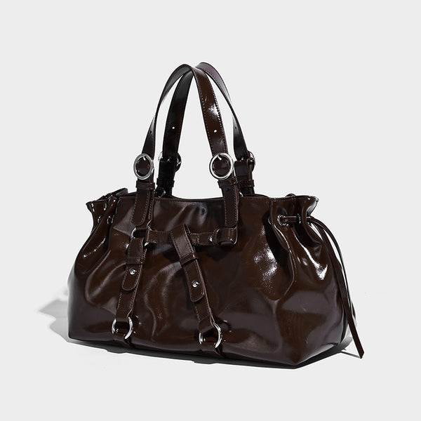 Glossy patent-look slouchy tote bag with ruched drawstring sides, dual top handles, silver ring hardware, and detachable