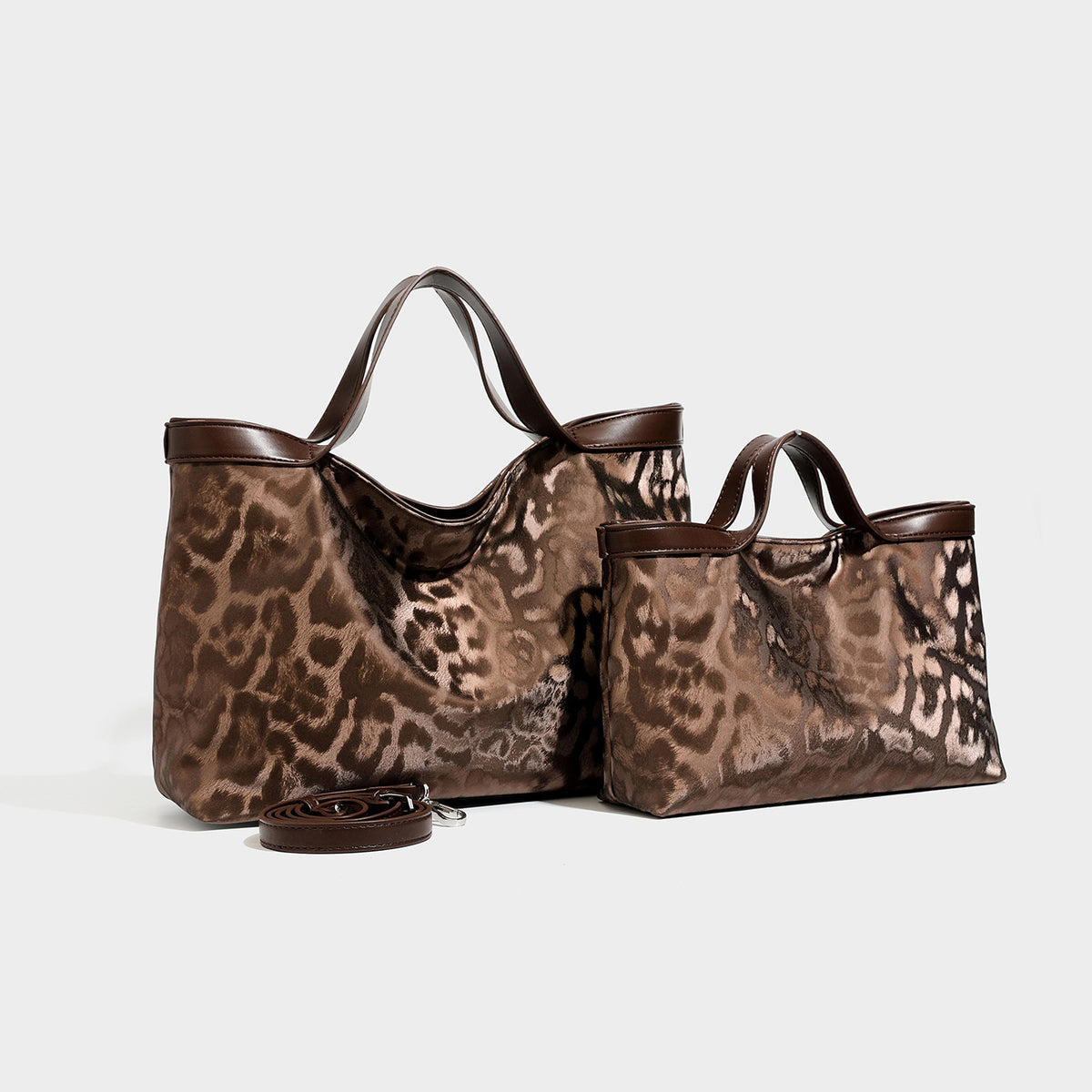 Glossy leopard-print tote bag with dark brown leather-look trim and dual top handles, front view