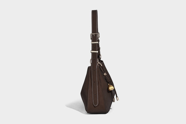 Crescent hobo shoulder bag in pebbled leather-look finish with top zipper, adjustable strap, gold-tone ring hardware, and