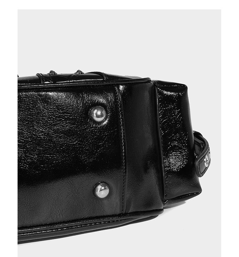 Compact glossy leather-look crossbody bag with silver studs, buckle hardware, and multiple zip pockets, detail view 14
