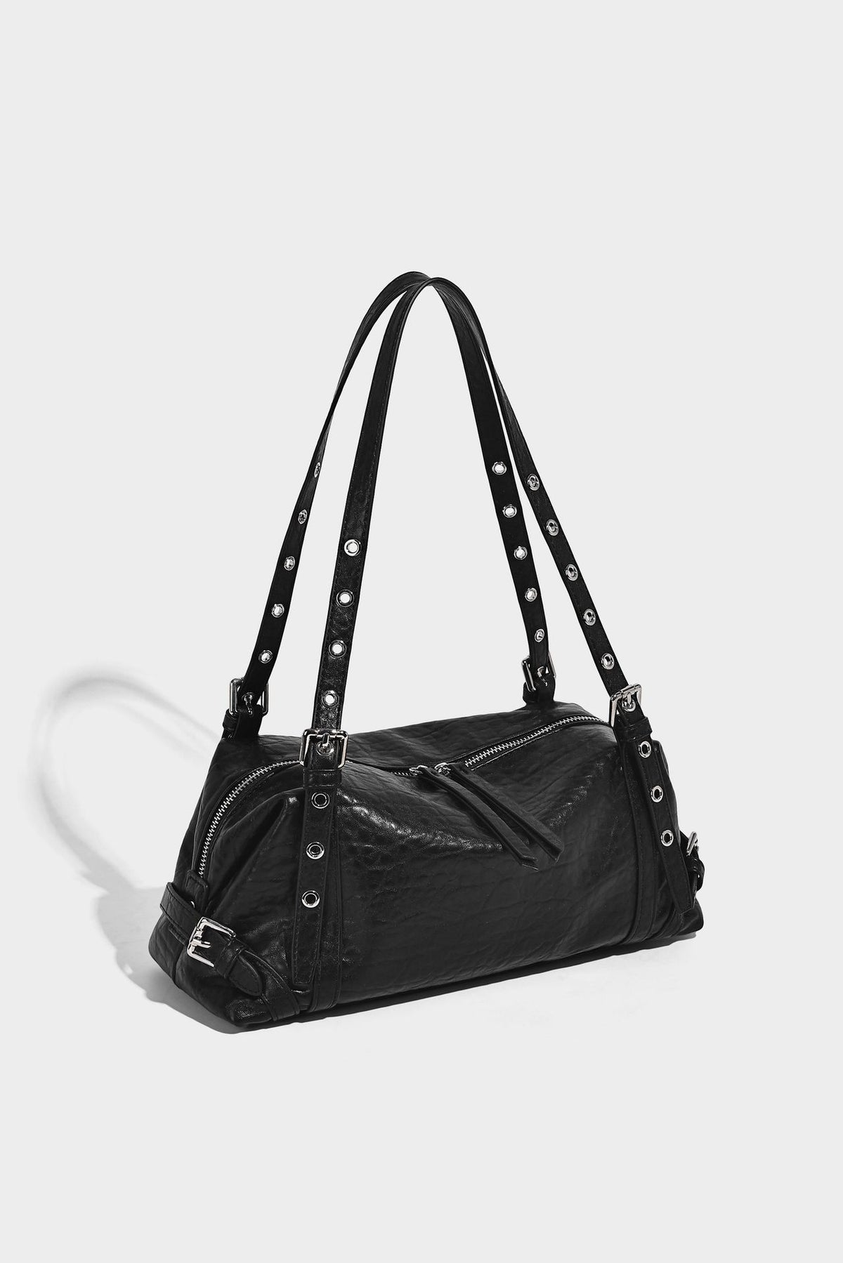 Pale yellow leather-look barrel bag with silver grommet-studded shoulder straps, top zip closure, and pink tulip floral