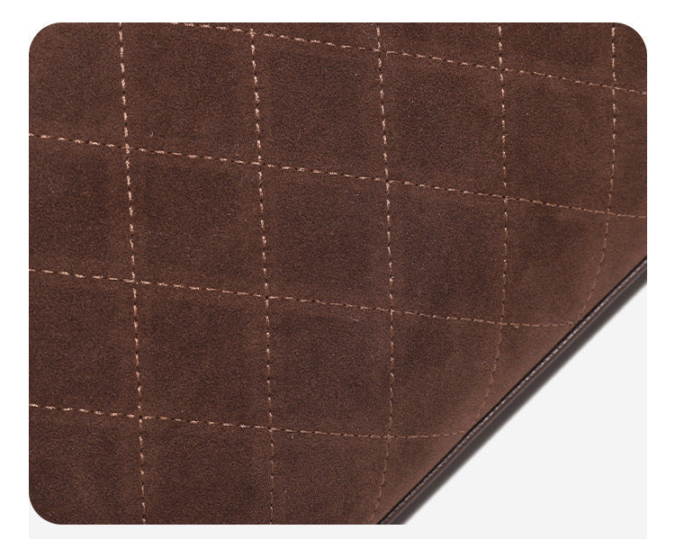 Structured quilted diamond top-handle underarm shoulder bag with gold-tone turn-lock flap closure and side tie straps, detail
