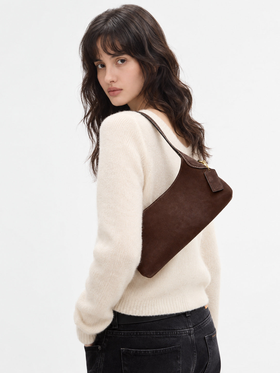 Slim crescent-silhouette shoulder bag in chocolate brown suede-look finish with contrast topstitching, top zip closure, thin