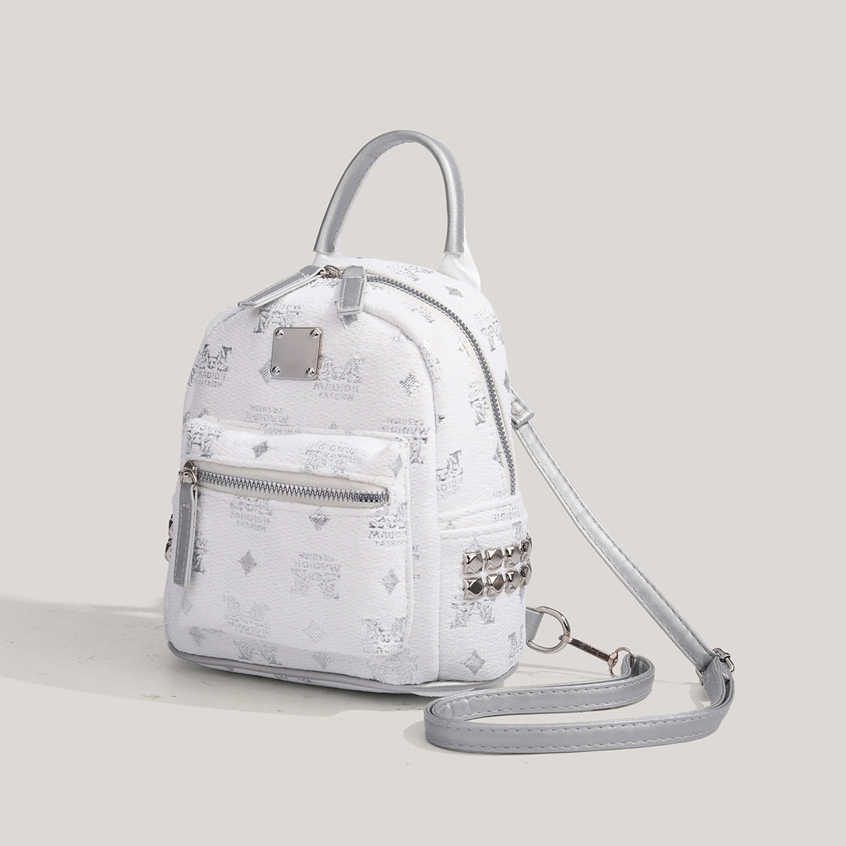Small structured silver dome mini backpack with pebbled embossed finish, silver-tone hardware, top handle, front zip pocket