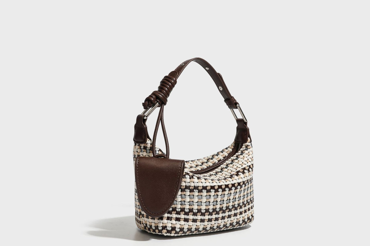 Small crescent shoulder bag in black-and-white woven textile with smooth black leather-look trim, zip-top closure, knotted