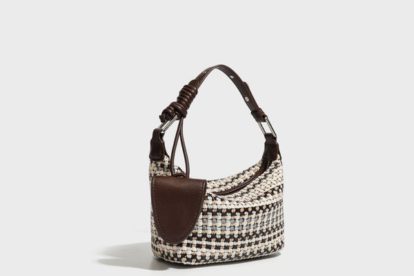 Small crescent shoulder bag in black-and-white woven textile with smooth black leather-look trim, zip-top closure, knotted