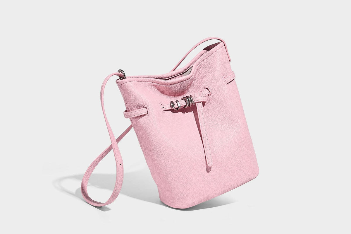 Small pebbled leather-look bucket bag with front drawstring toggle hardware and long adjustable shoulder strap, detail view