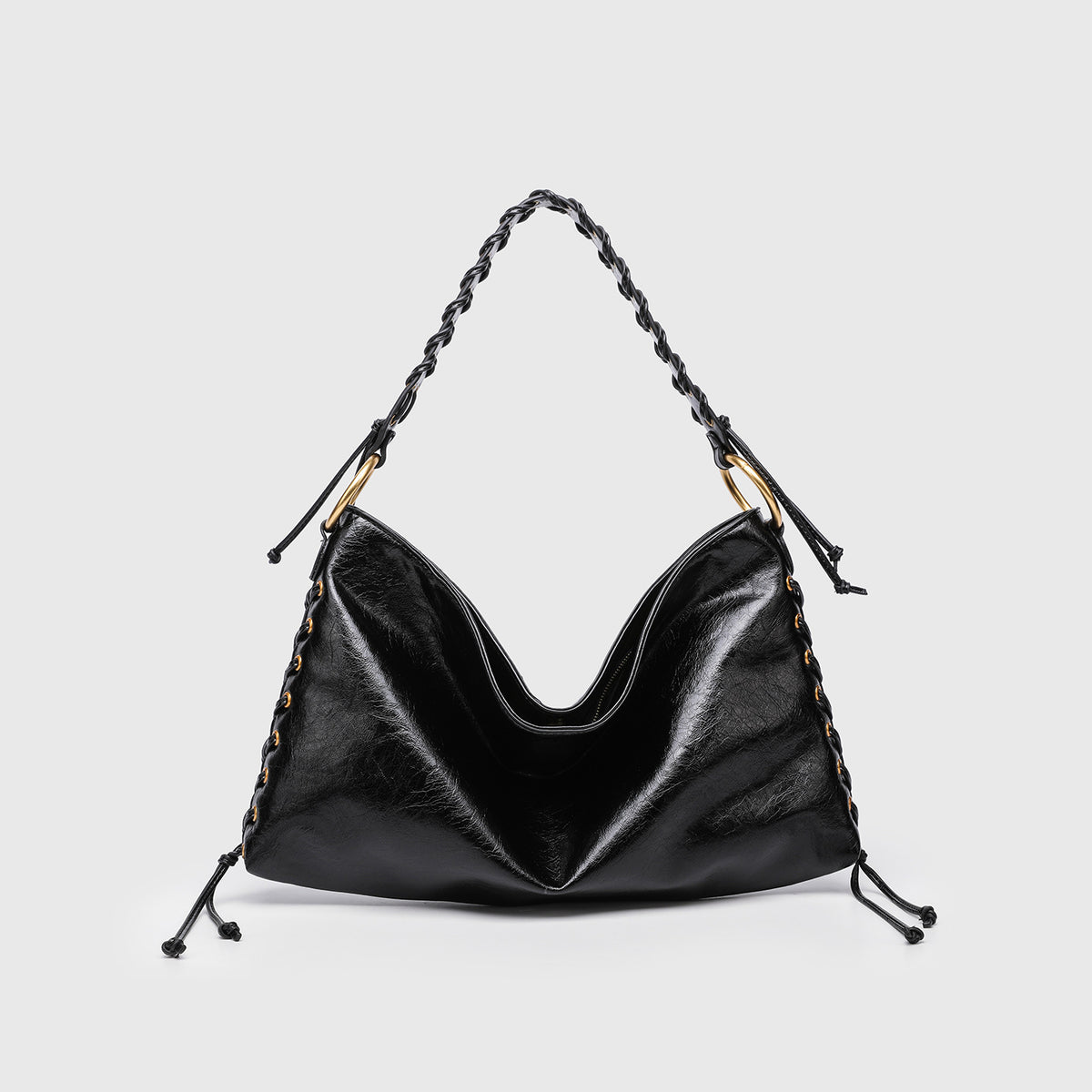 Large slouchy hobo shoulder bag with braided top handle, gold-tone O-ring hardware, and lace-up side cord detailing in