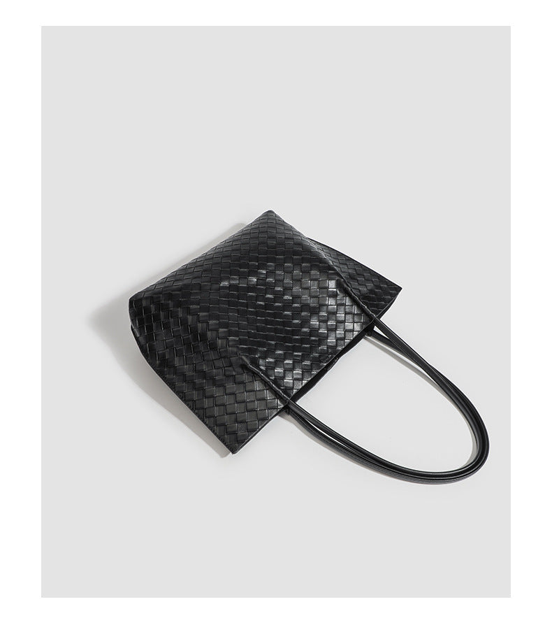 Large black woven leather-look tote bag with twin shoulder straps and matching inner pouch, detail view 9