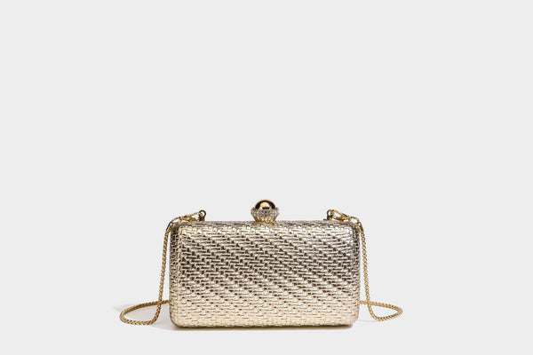 Small structured metallic woven-texture box clutch bag with jeweled kiss-lock dome clasp and slim gold chain strap, detail